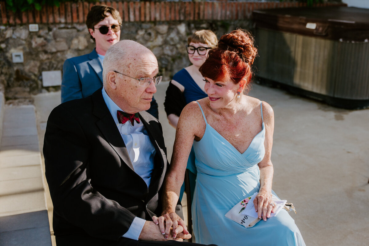 Guests watching ceremony on terrace overlooking the sea