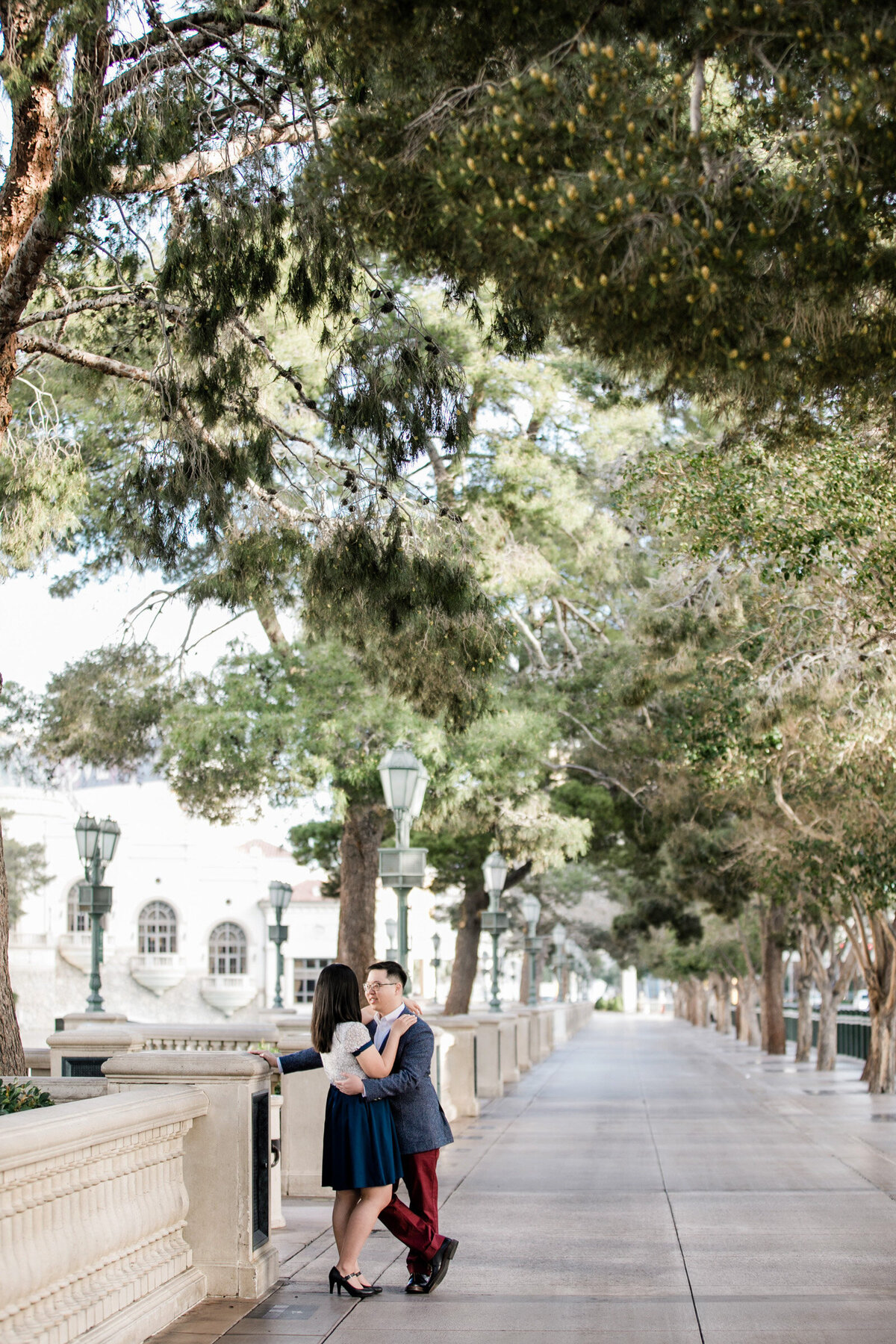 Engaged couple sharing a classic hug near the Bellagio in Las Vegas, standing in a charming alleyway behind the hotel