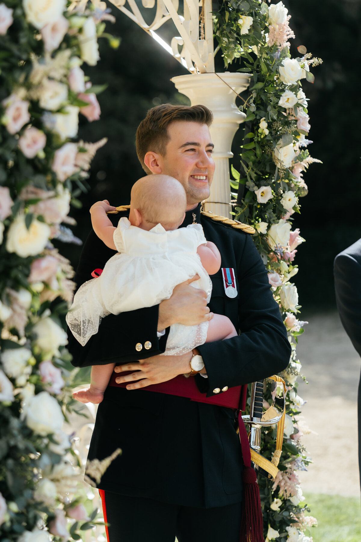 Groom-Holding-Baby-At-Aisle