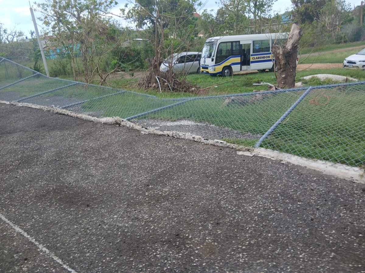 School yard with debris and uprooted materials scattered across the grounds after the hurricane.