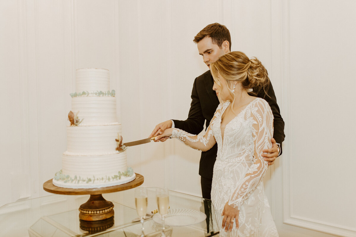 bride and groom cutting cake