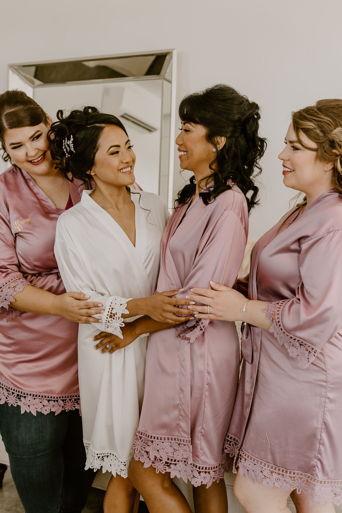 wedding-bride-laughing-with-bridesmaids-getting-ready-emerald-hills-events-promise-city-iowa-des-moines-wedding-photographer-storyteller-collective-photo-co