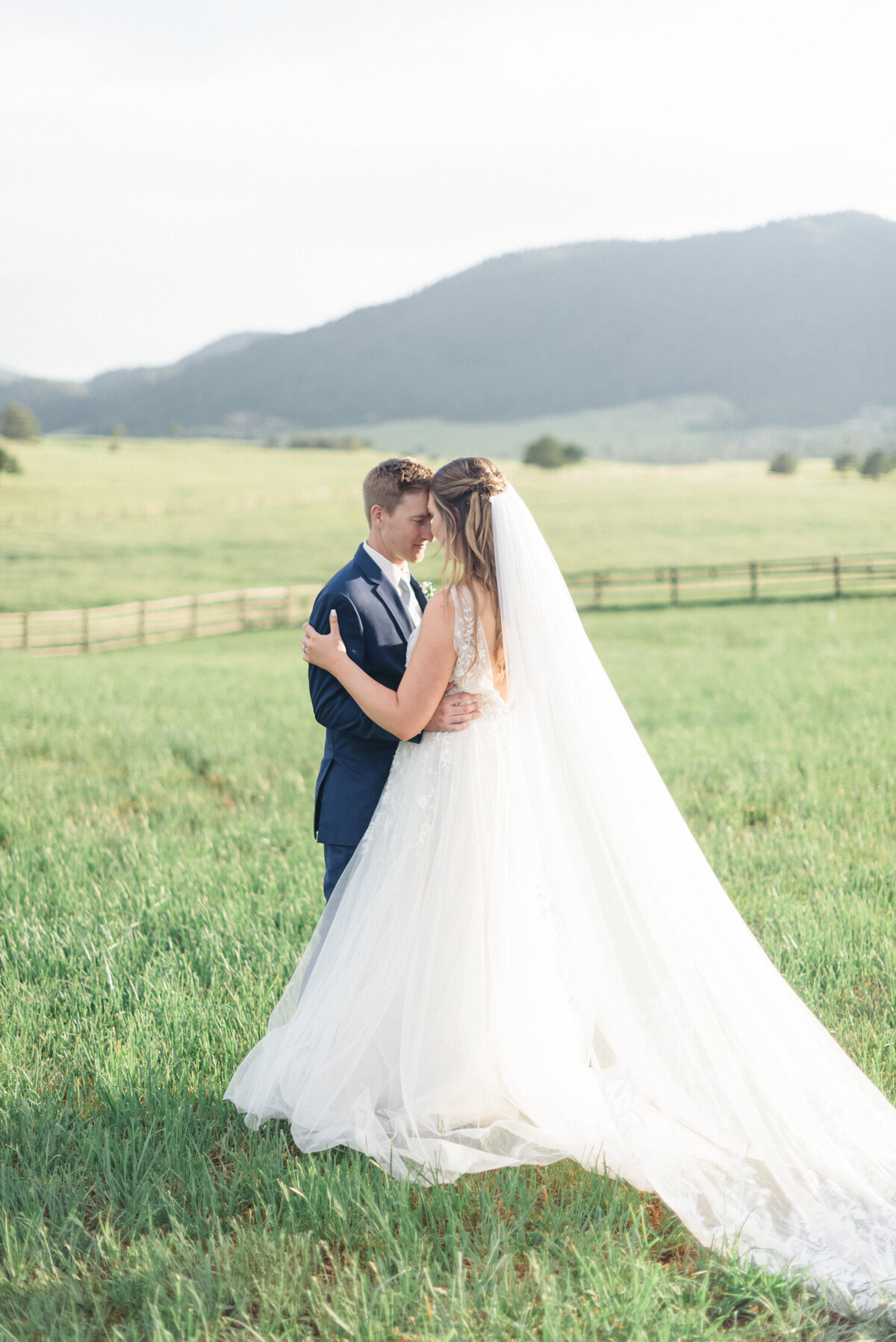 Summer dusty blue wedding at Spruce Mountain Ranch, Larkspur, Colorado. Bride & groom sunset portraits.