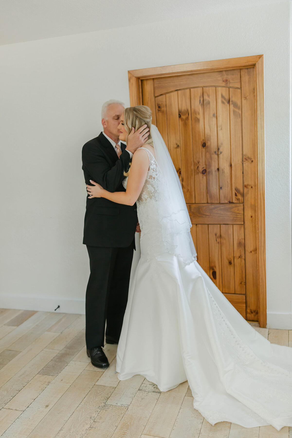 father kissing the bride
