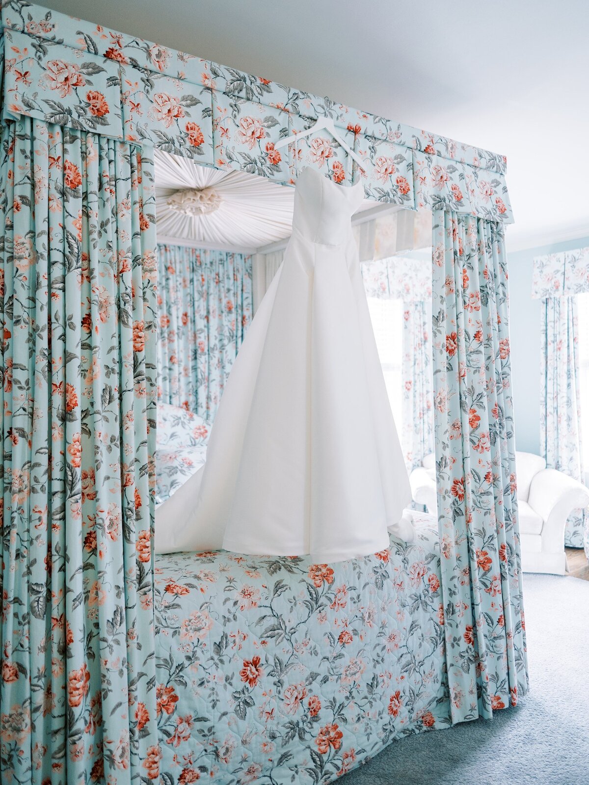Wedding dress hanging on a floral drapery