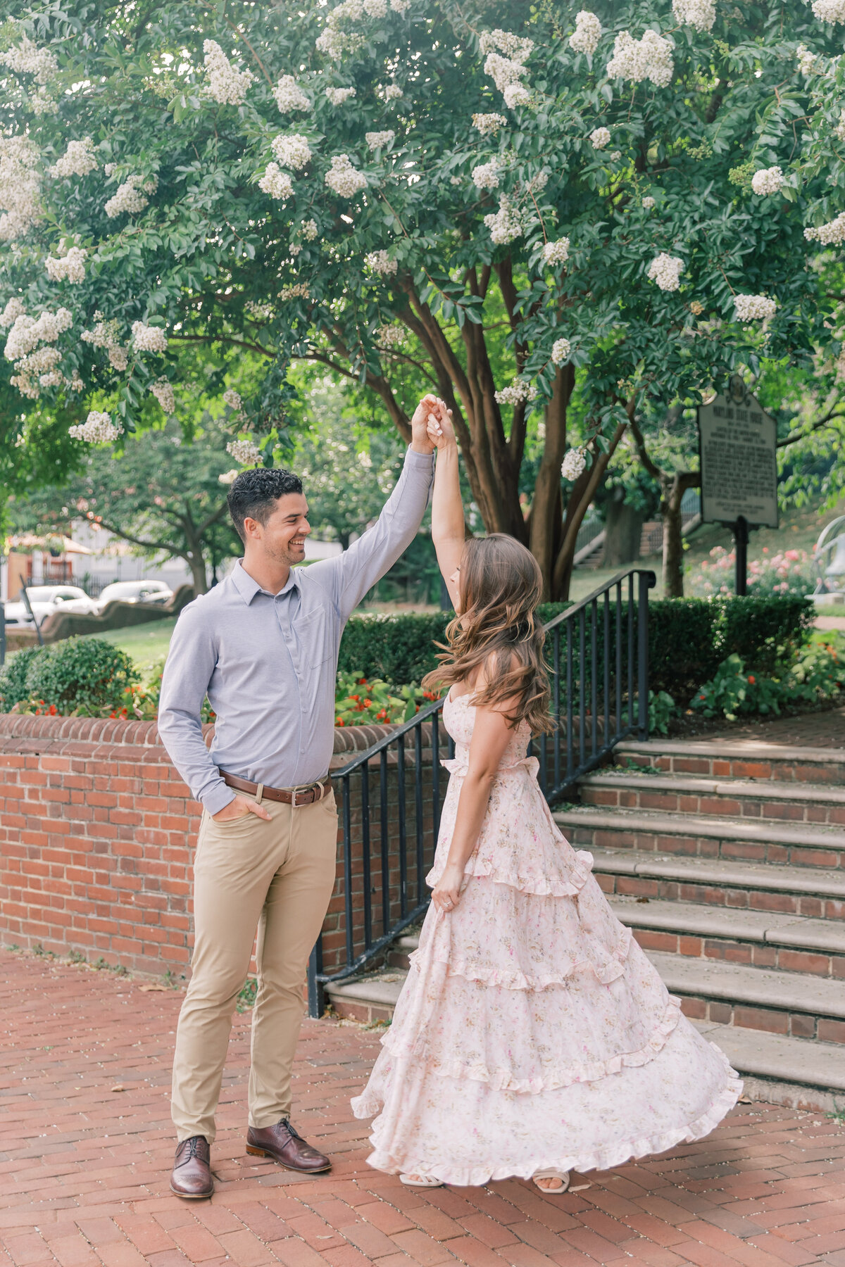 Couple twirling in Annapolis during engagement session