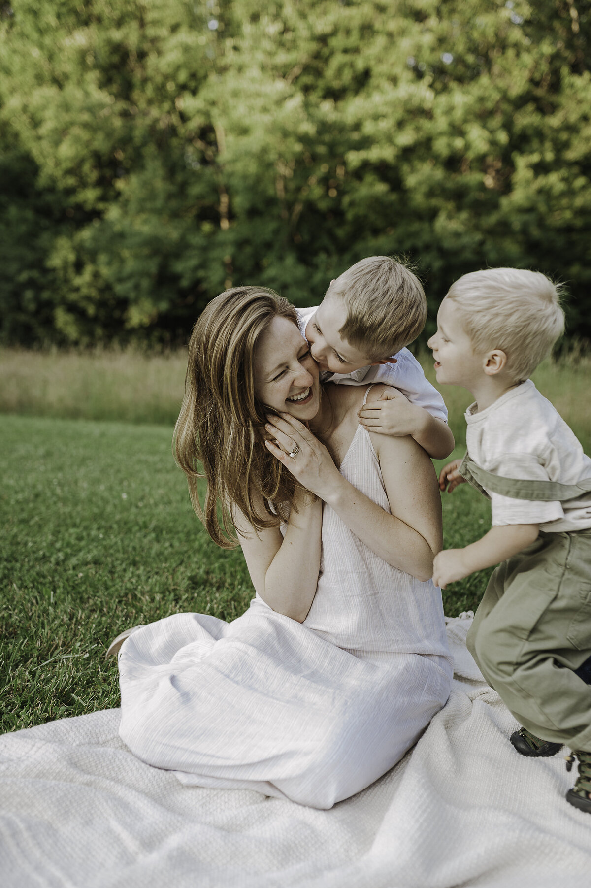 Verona B Photography captures a beautiful summer family photo of a mom and her two boys at Silver Creek Metro Park in Norton, OH. The boys were kissing and tickling their mom and and it was so wonderful to capture the love between them in this beautiful field setting near Akron.