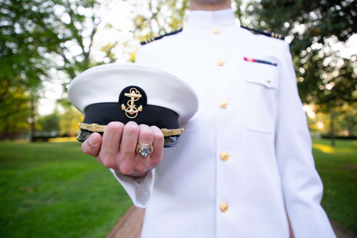 Midshipman Cover and Class ring details photograph by Kelly Eskelsen Photography in Annapolis, Maryland.