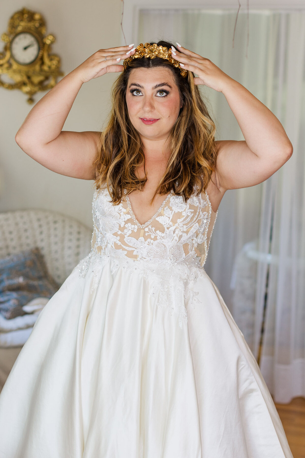 Bride-puts-on-her-bridal-crown-as-she-gets-ready-for-her-wedding-ceremony-at-Vashon-Field-in-Pond-venue-near-Seattle-photo-by-Joanna-Monger-Photography