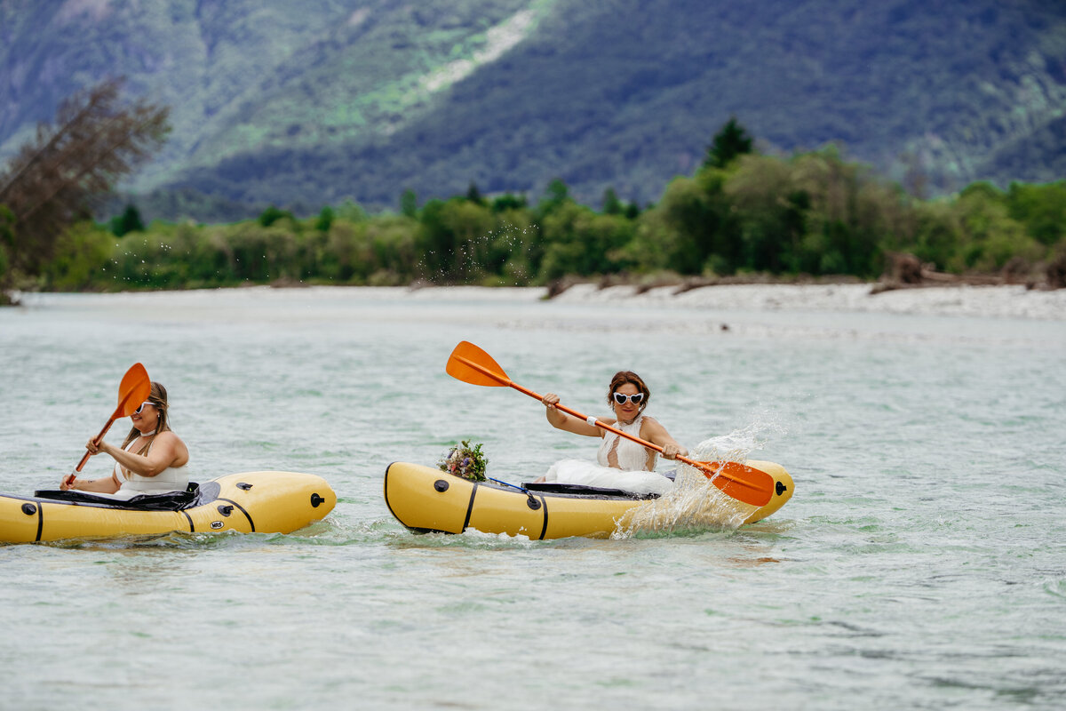 romantic couple in wedding dresses kayaking Soča River