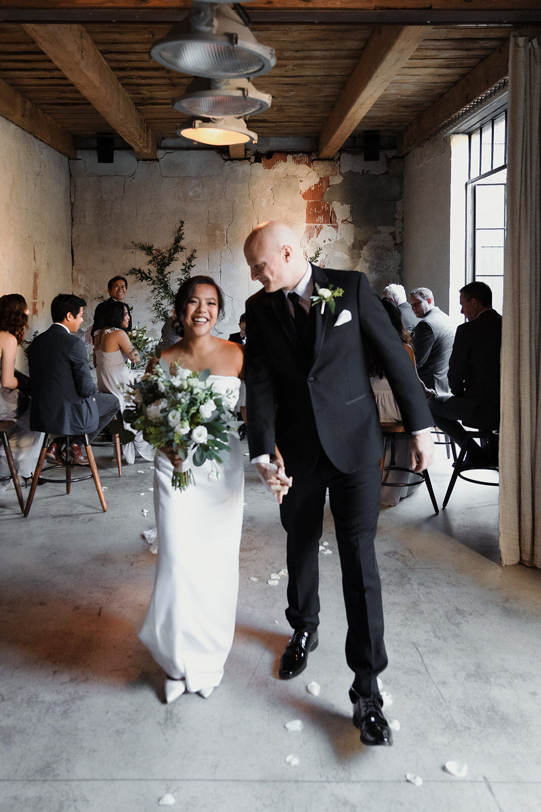 couple walking down the aisle very happy