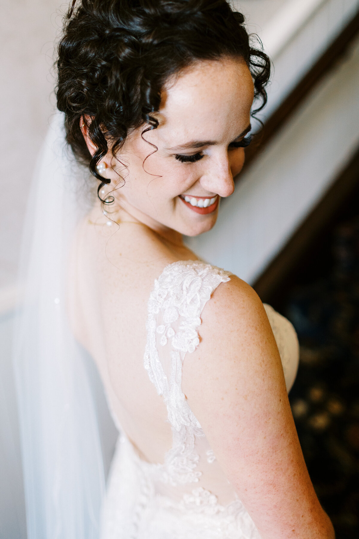 bride looking over her shoulder and posing for Minneapolis wedding photographer