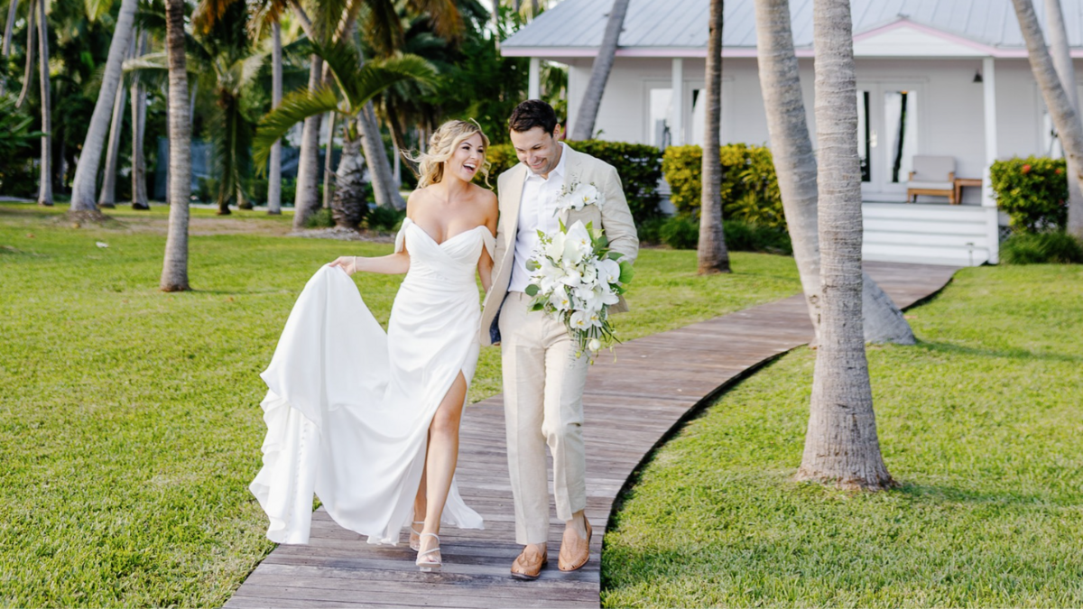 Happy couple walking at Casitas at Cheeca Lodge captured by Claudia Amalia Photography, a Miami and Florida Keys wedding and lifestyle photographer specializing in destination weddings