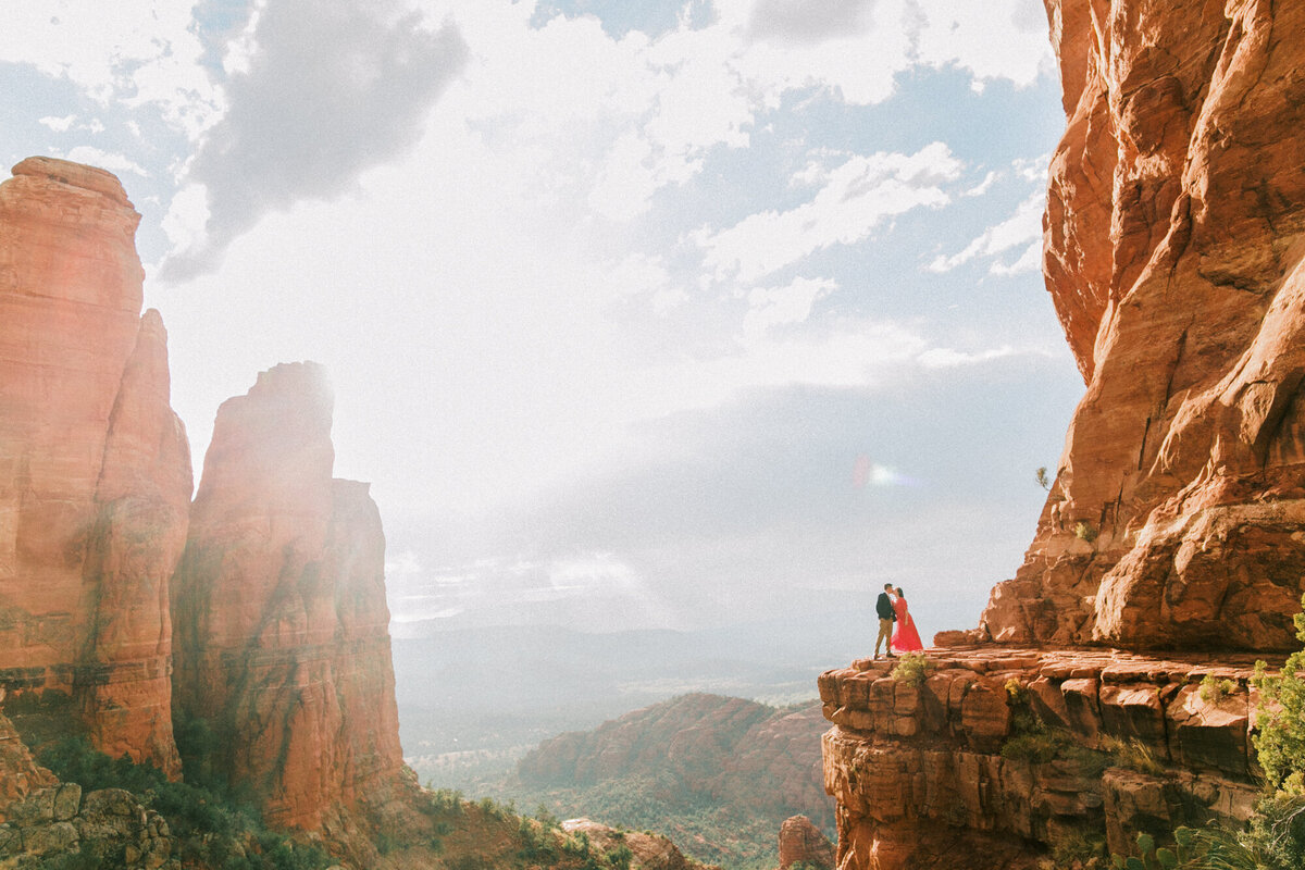 A sunset engagement photo taken at the top of Cathedral Rock in Sedona, Arizona