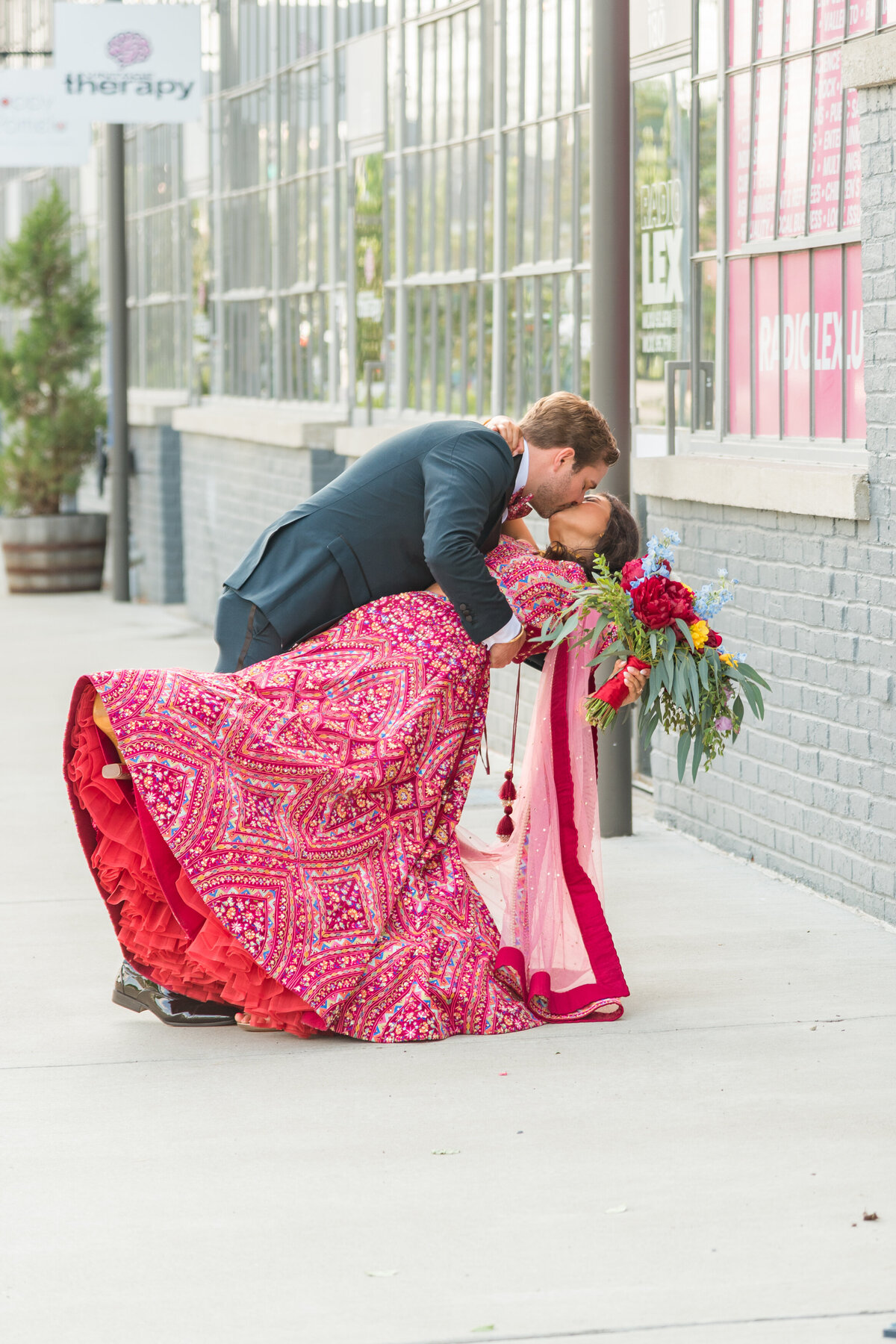 groom dipping bride in front of the Celestory in Lexington