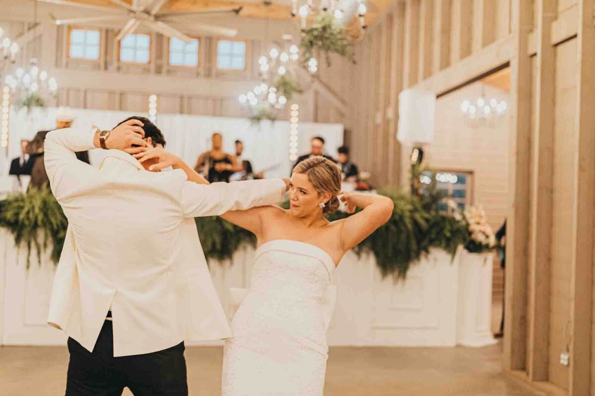 bride and groom dance with each other for their last dance of the night.