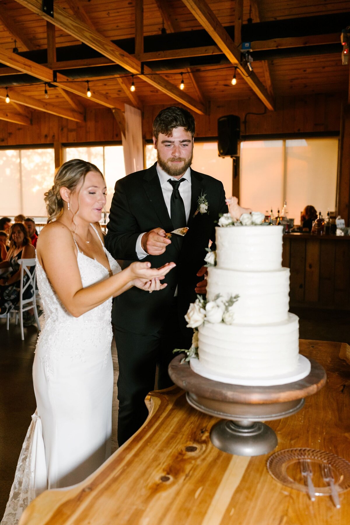 cutting-wedding-cake-bride-and-groom-lewallen-farms-waleska-ga