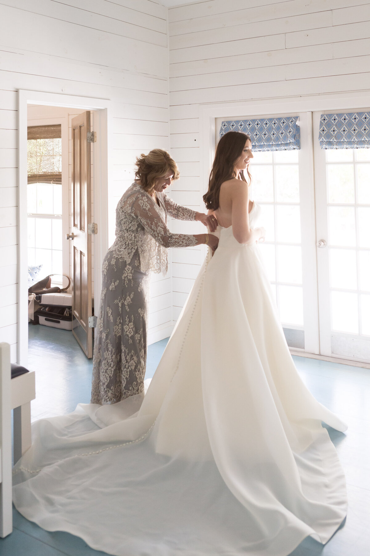 The bride and her mom have an intimate moment as they prepare for her wedding day.