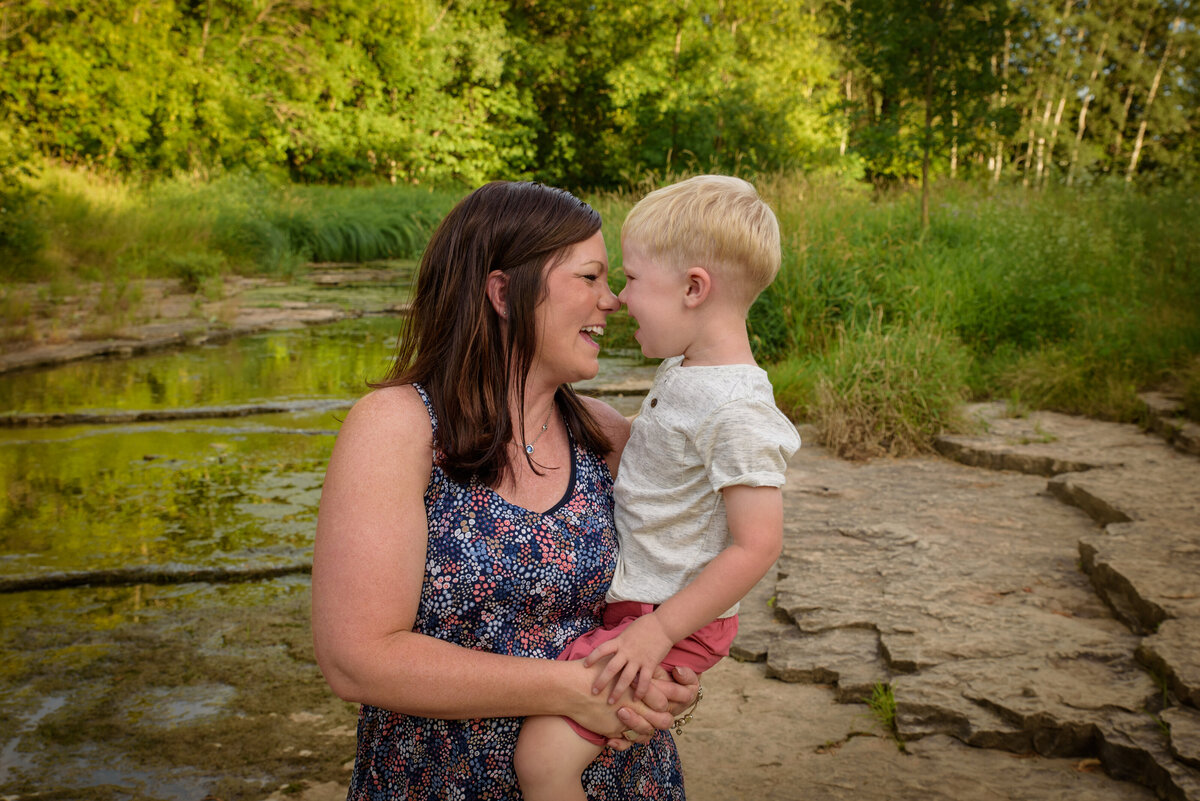 Mother and son portrait standing near creek at Fonferek Glen County Park near Green Bay, Wisconsin