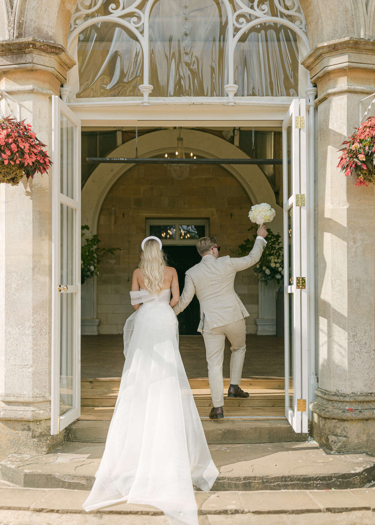 chloe-winstanley-weddings-grittleton-house-conservatory-bride-groom-dinner-entrance