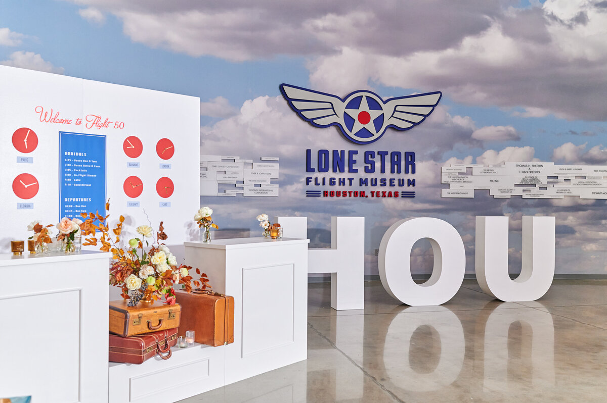 Lone Star Flight Museum Houston exhibit backdrop display with luggage and floral decor