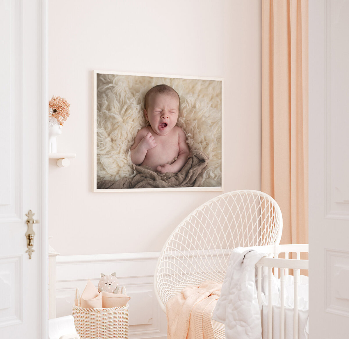 nursery with a framed print on the wall of a baby yawning at their st. louis newborn photo session