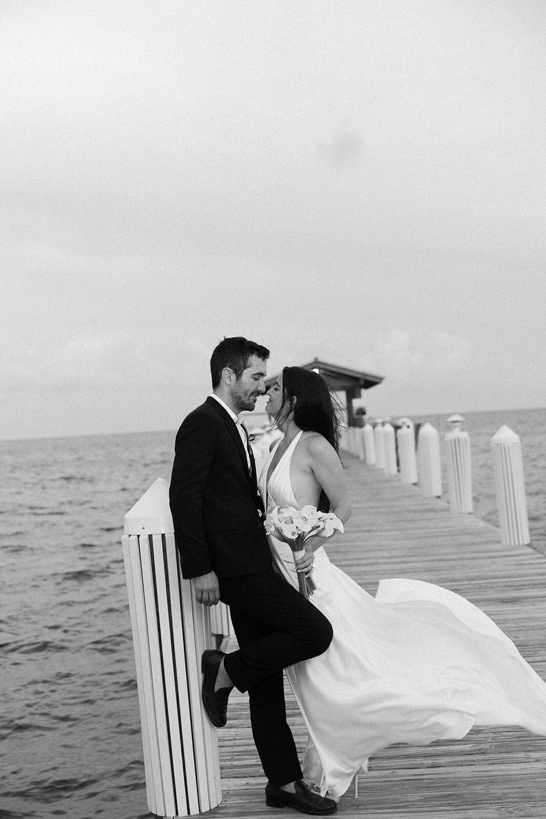 A timeless moment as Minette and Evan share a romantic embrace with the ocean in the background. Islamorada wedding photography by Claudia Amalia.