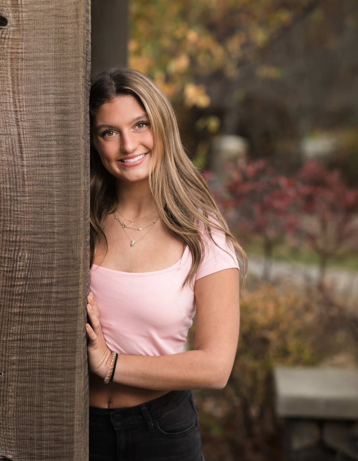 senior girl in pink shirt posing for senior portraits at Westcreek Reservation in Parma, Ohio