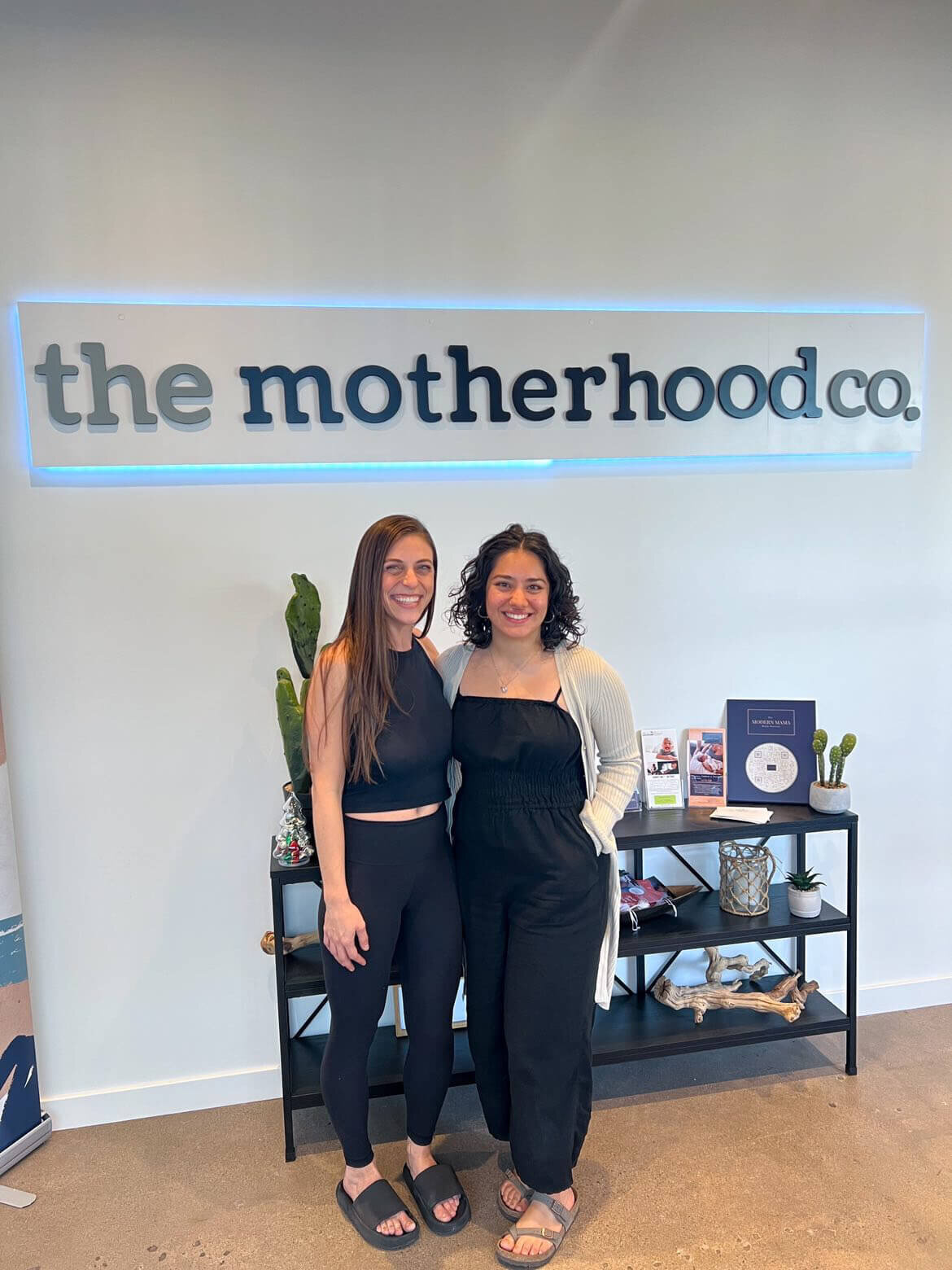 owner and friend smiling for photo at the motherhood co in Phoenix