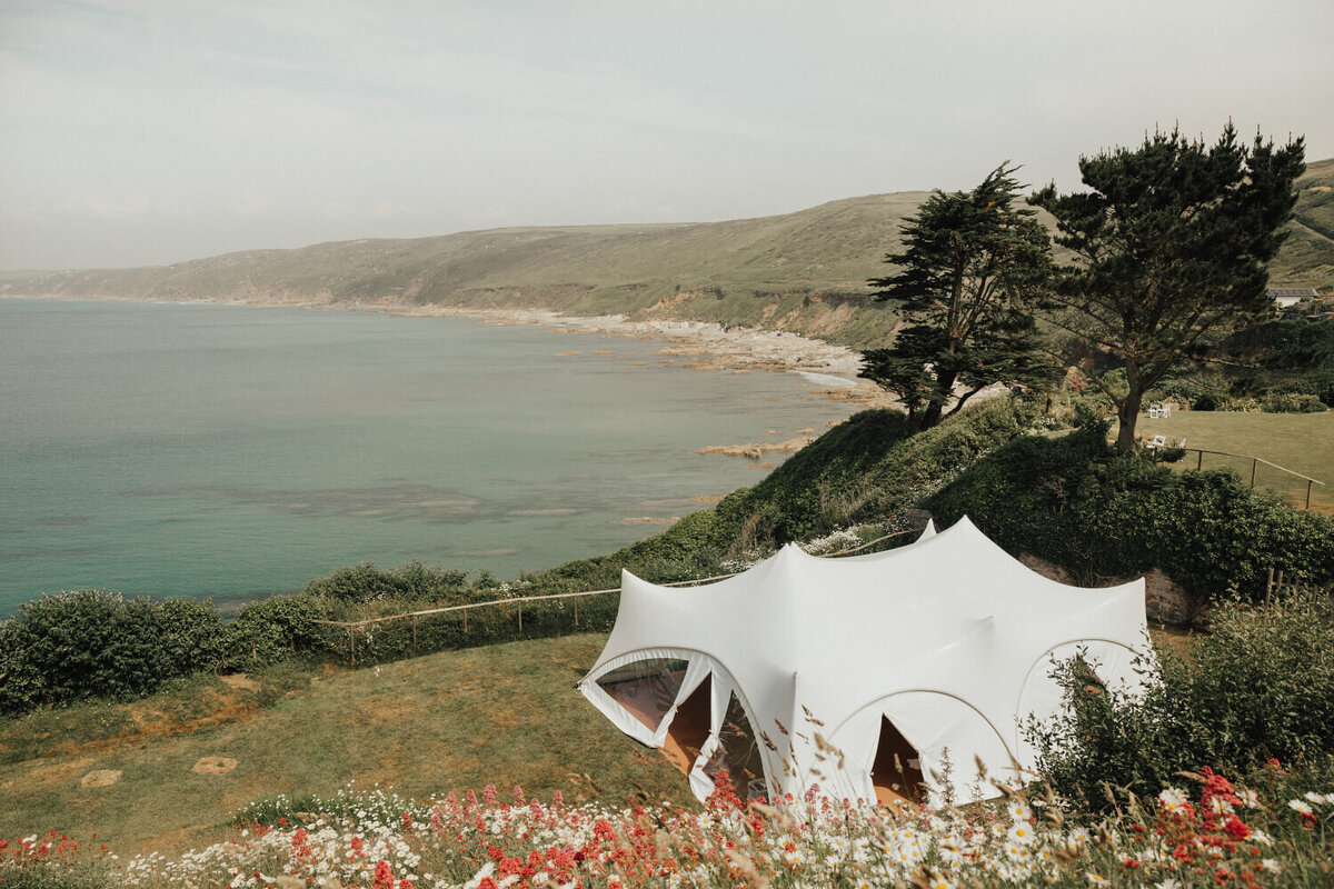 A stretch marquee on the lawn at Polhawn Fort