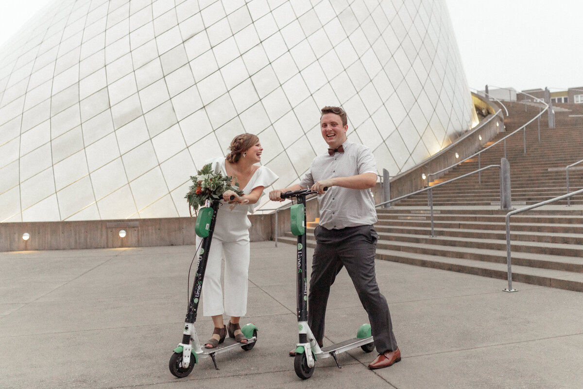 bride and groom riding scooters