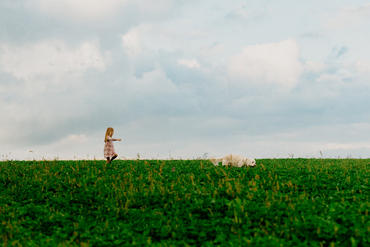 girl with dog in field