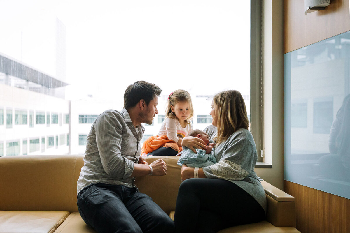 parents introducing newborn to big sister in a San Francisco hospital