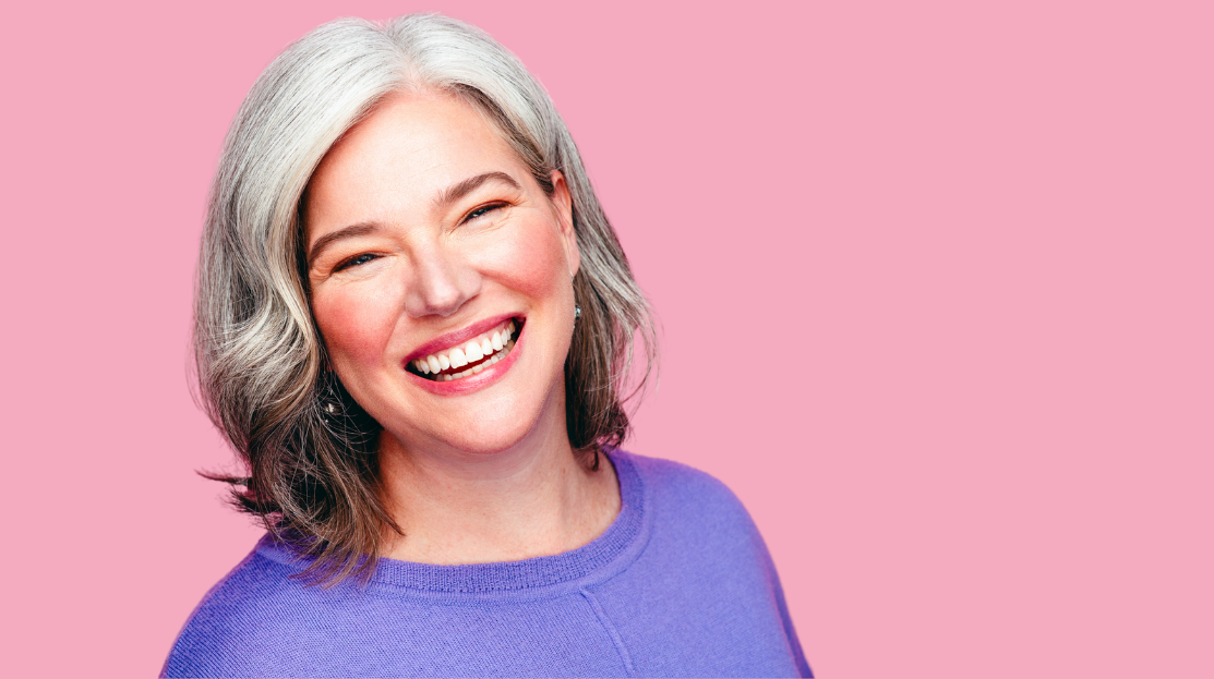 headshot of M.J. Johnson wearing a purple shirt in front of a pink background.