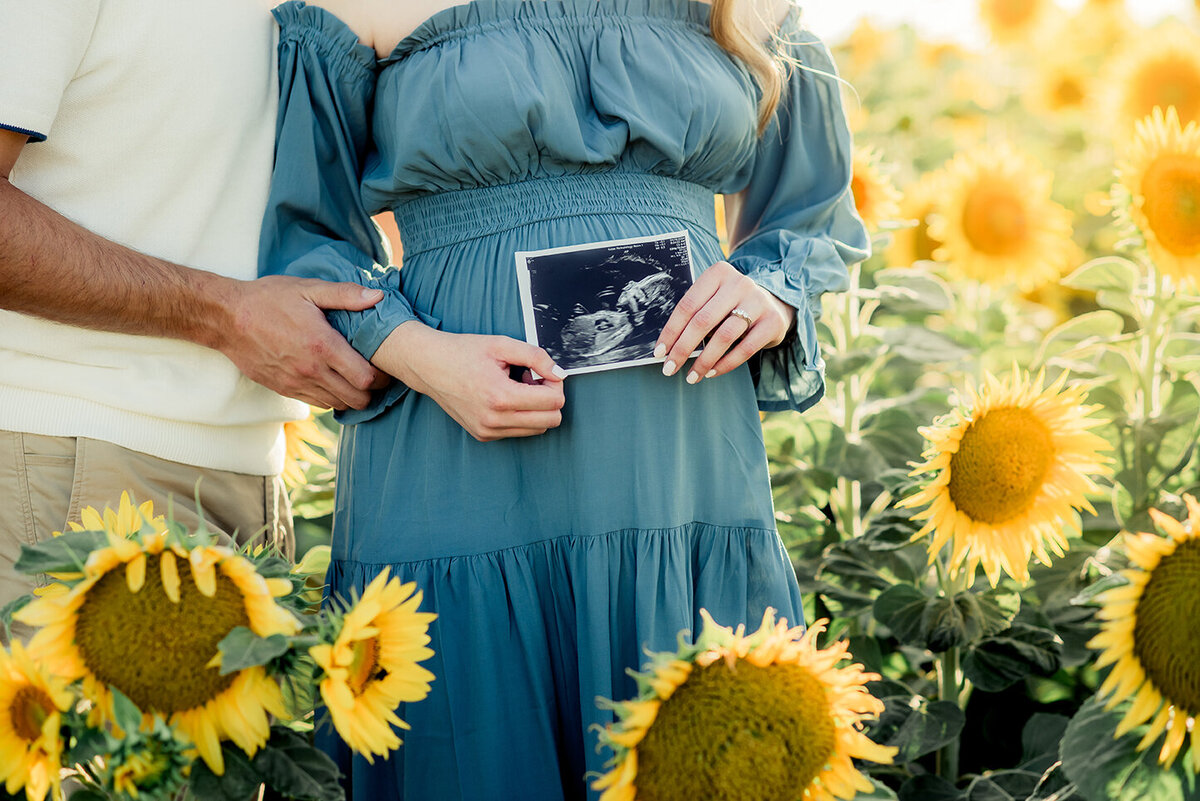 couple with baby photo in flowers