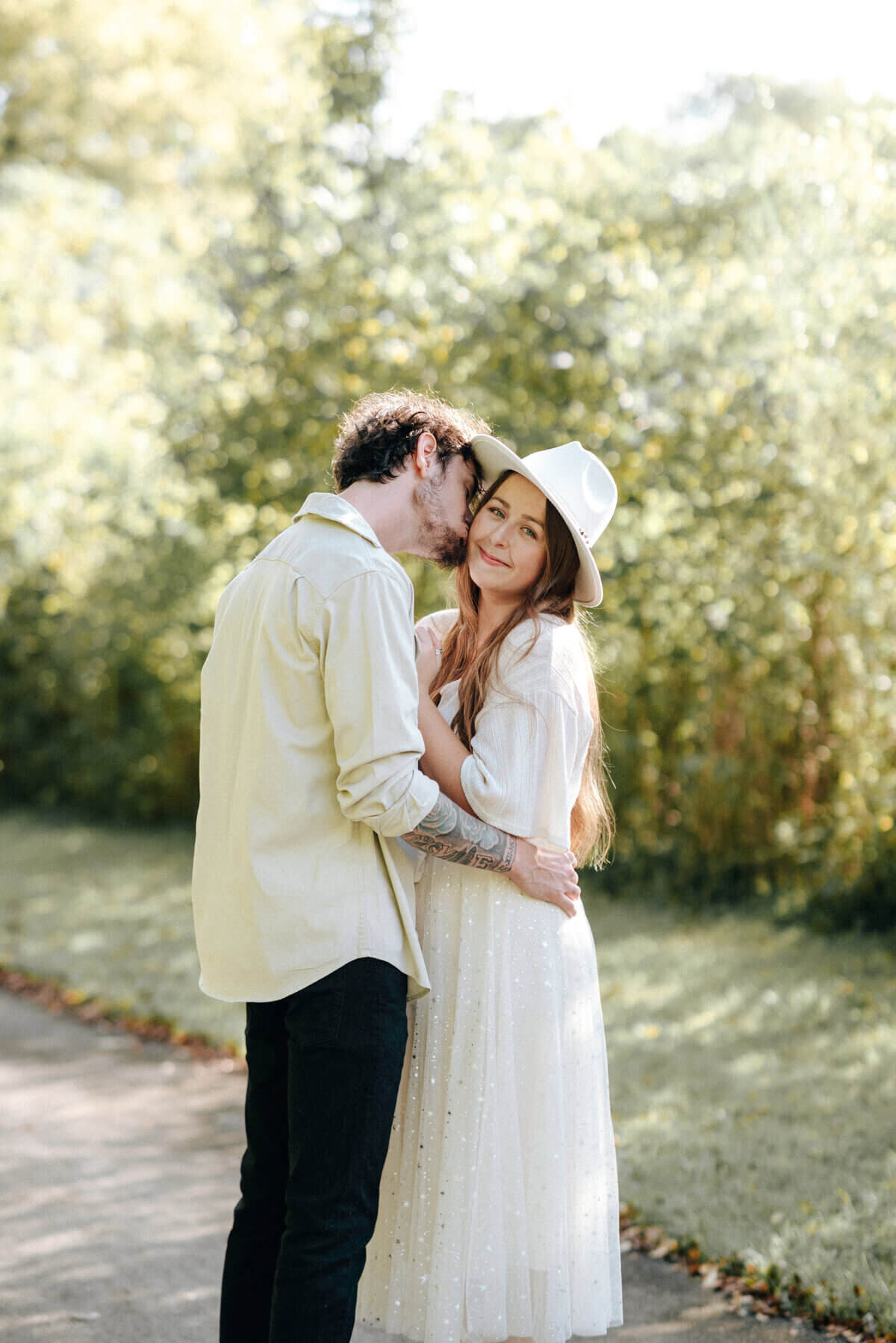 couple wearing white embracing taken by nashville engagement photographers