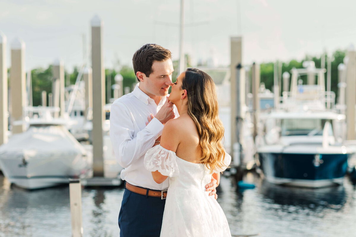 a couple about to kiss  on a marina