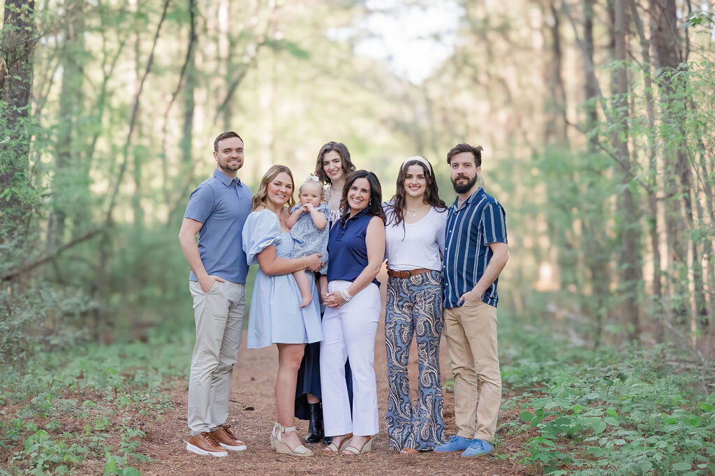 Extended family smiling at camera during fall family session in Davidson NC