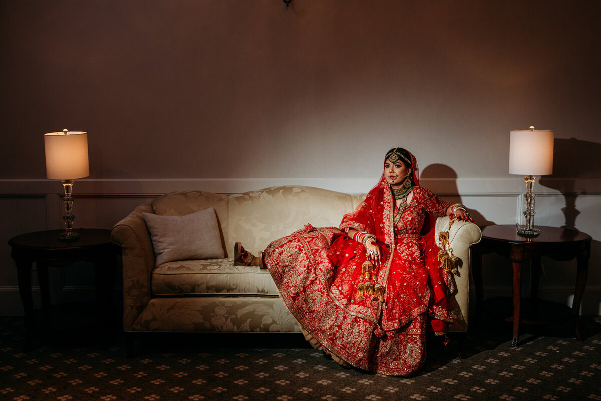 Stunning Muslim bride sits for portrait in traditional wedding ceremonial attire