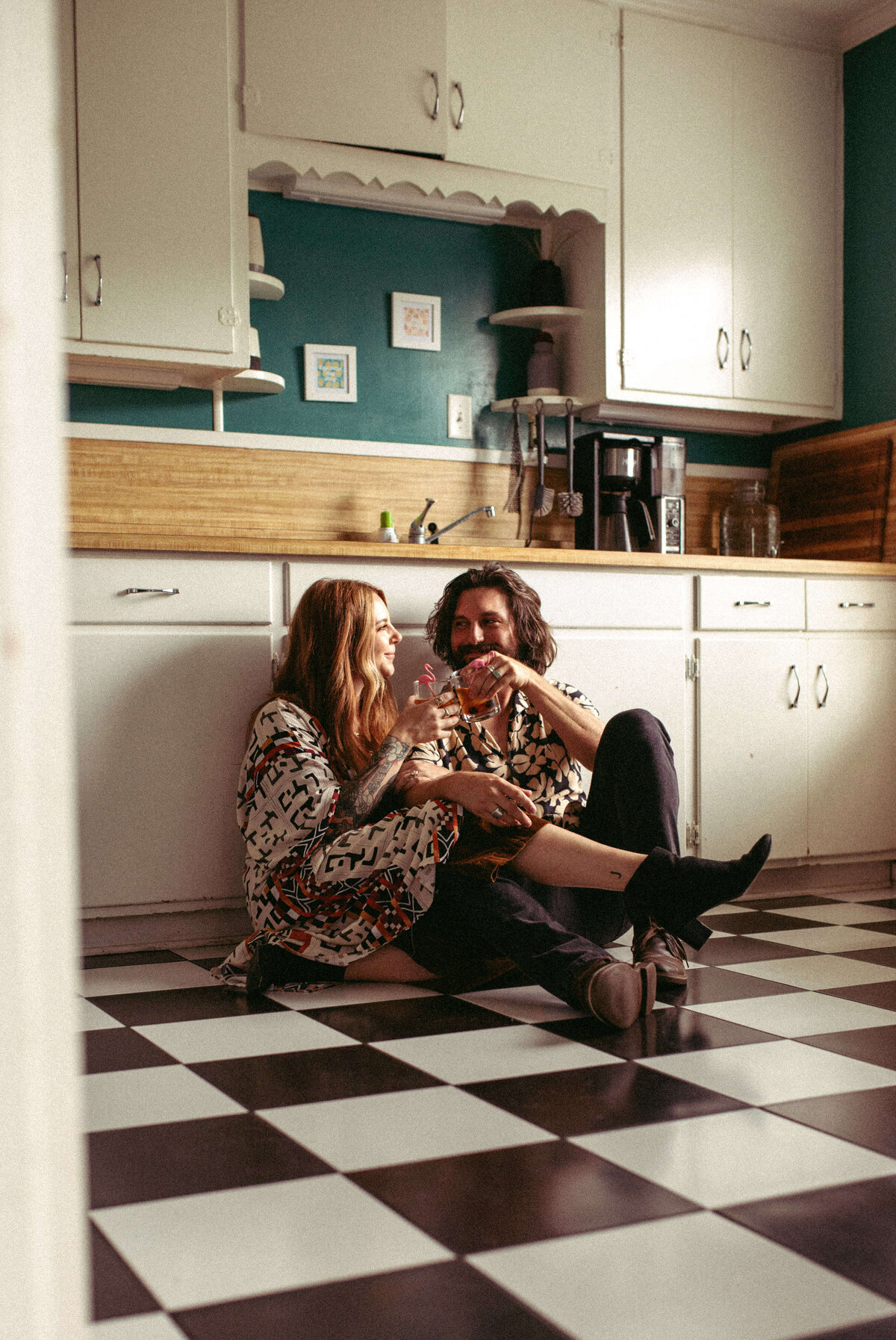 engaged couple sit cozy in retro kitchen in panama city fl
