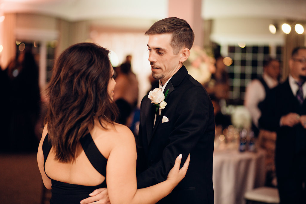 Wedding Photograph Of Groom Looking At a Woman In Black Dress While Dancing Los Angeles