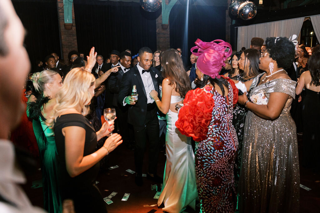 A group of wedding guests dancing at the reception. 