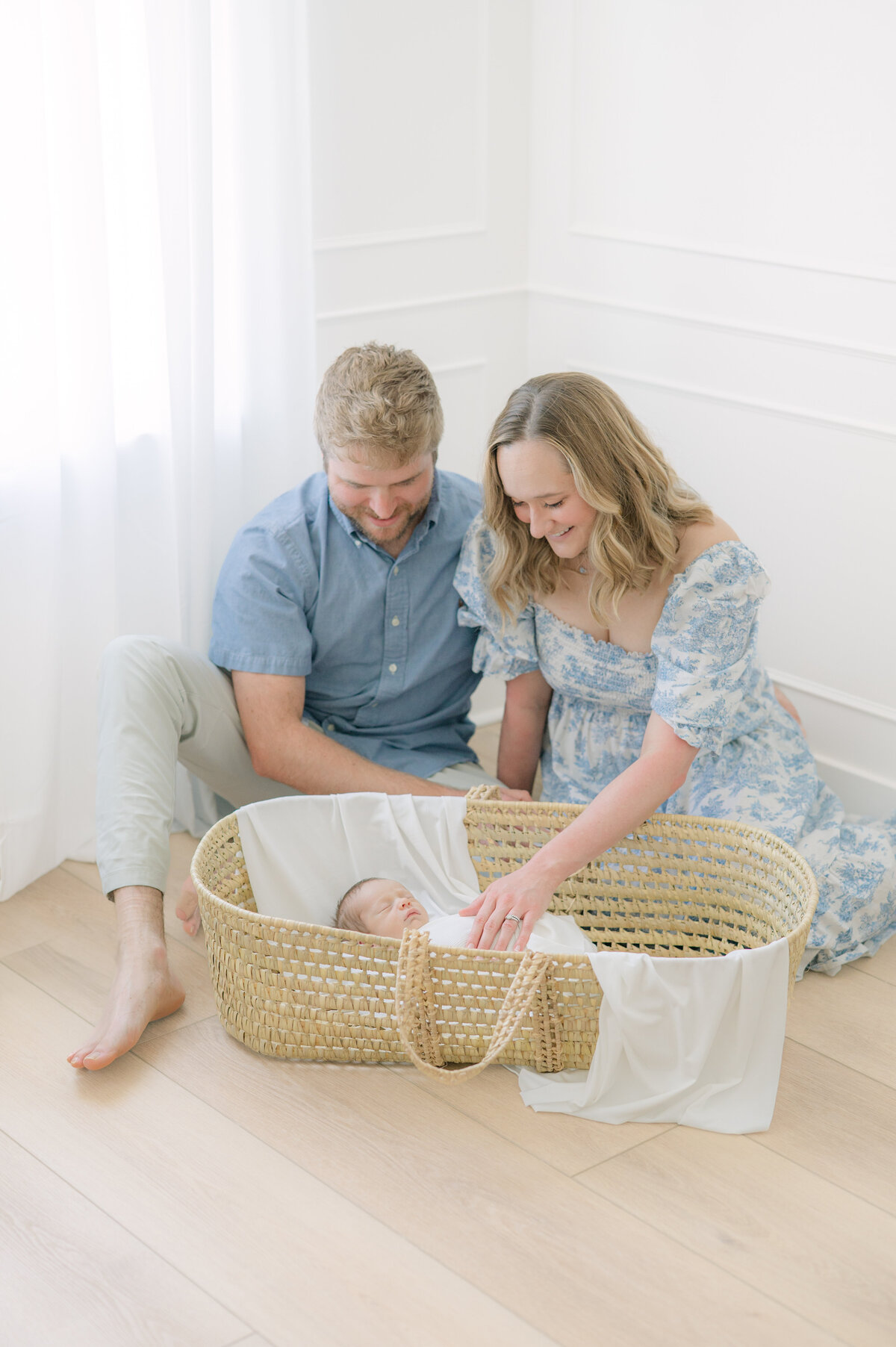 Family with baby in basket by newborn photographer raleigh 