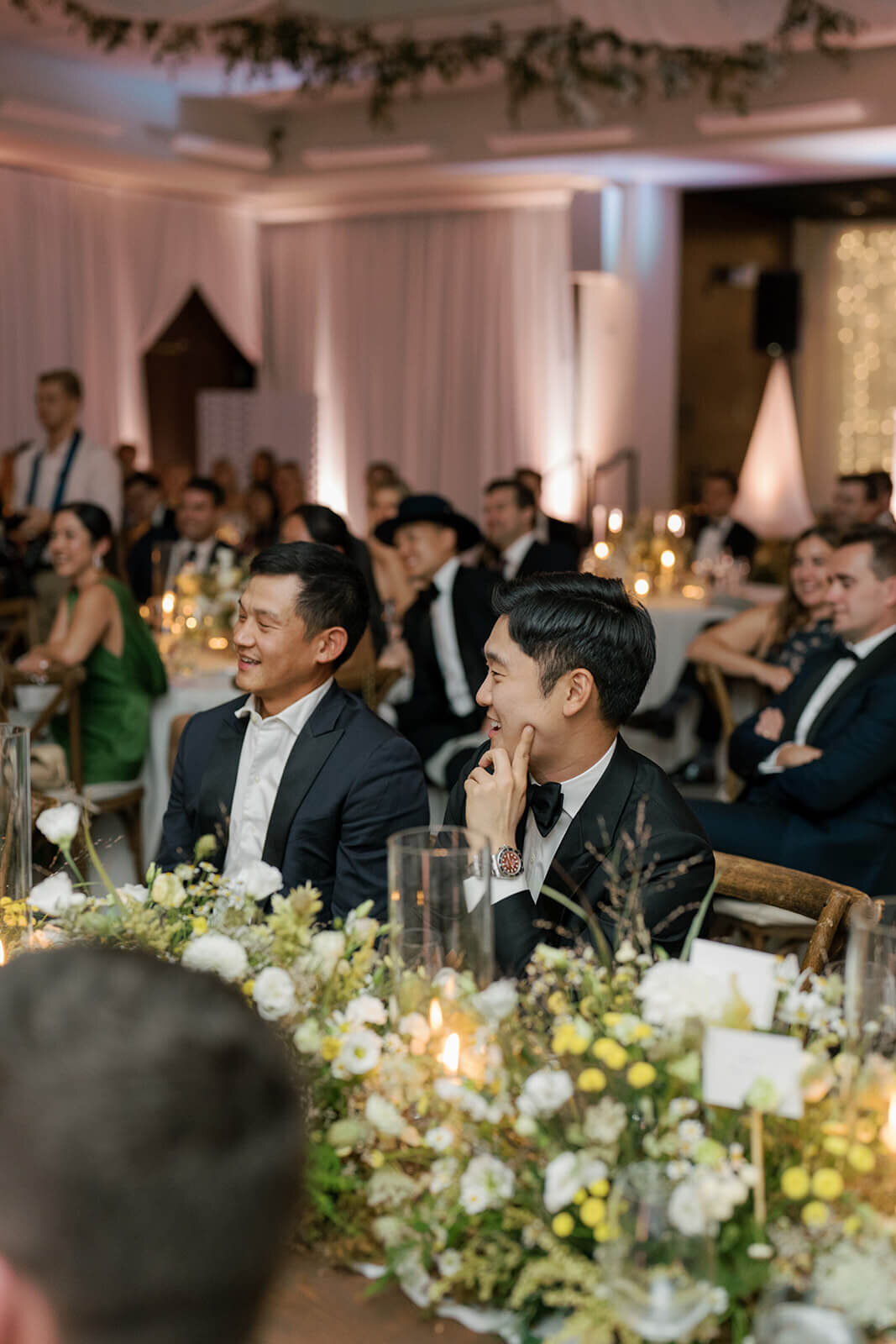 Guests enjoy dinner surrounded by warm candlelight at the Aspen Meadows Resort wedding reception venue.