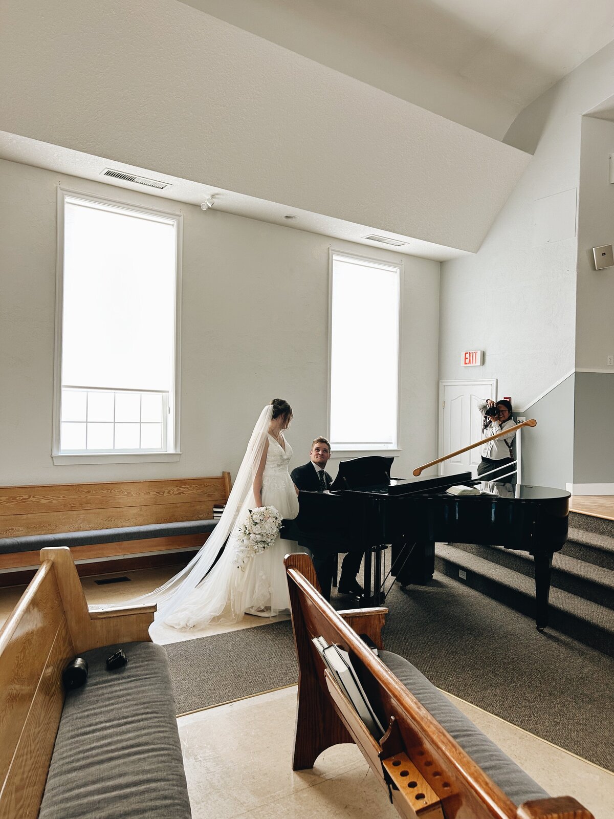 Couple posing at the baby grand piano