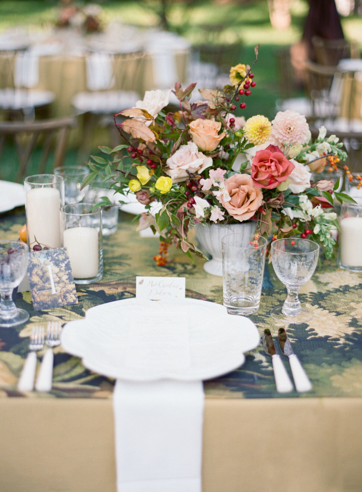 Lush fall florals for low and high centerpieces at fall wedding reception. Clear tented wedding reception in the family's back yard creating an intimate wedding reception environment. Whimsical and organic floral design in colors of copper, yellow, blush,and brown. Fall florals with sweet peas, dahlias, butterfly ranunculus, roses, mums, and bittersweet berries. Design by Rosemary & Finch Floral Design in Nashville, TN.