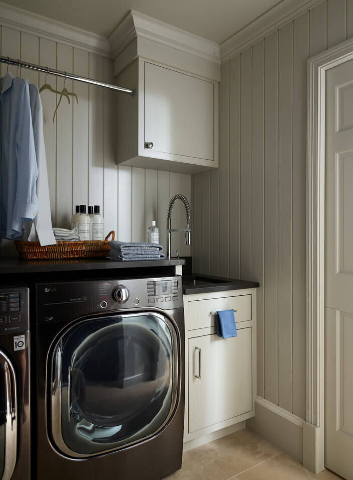 Hingham kitchen and bath designer creates a light grey mudroom with custom cabinets at a Hingham home, blending modern design with classic charm.