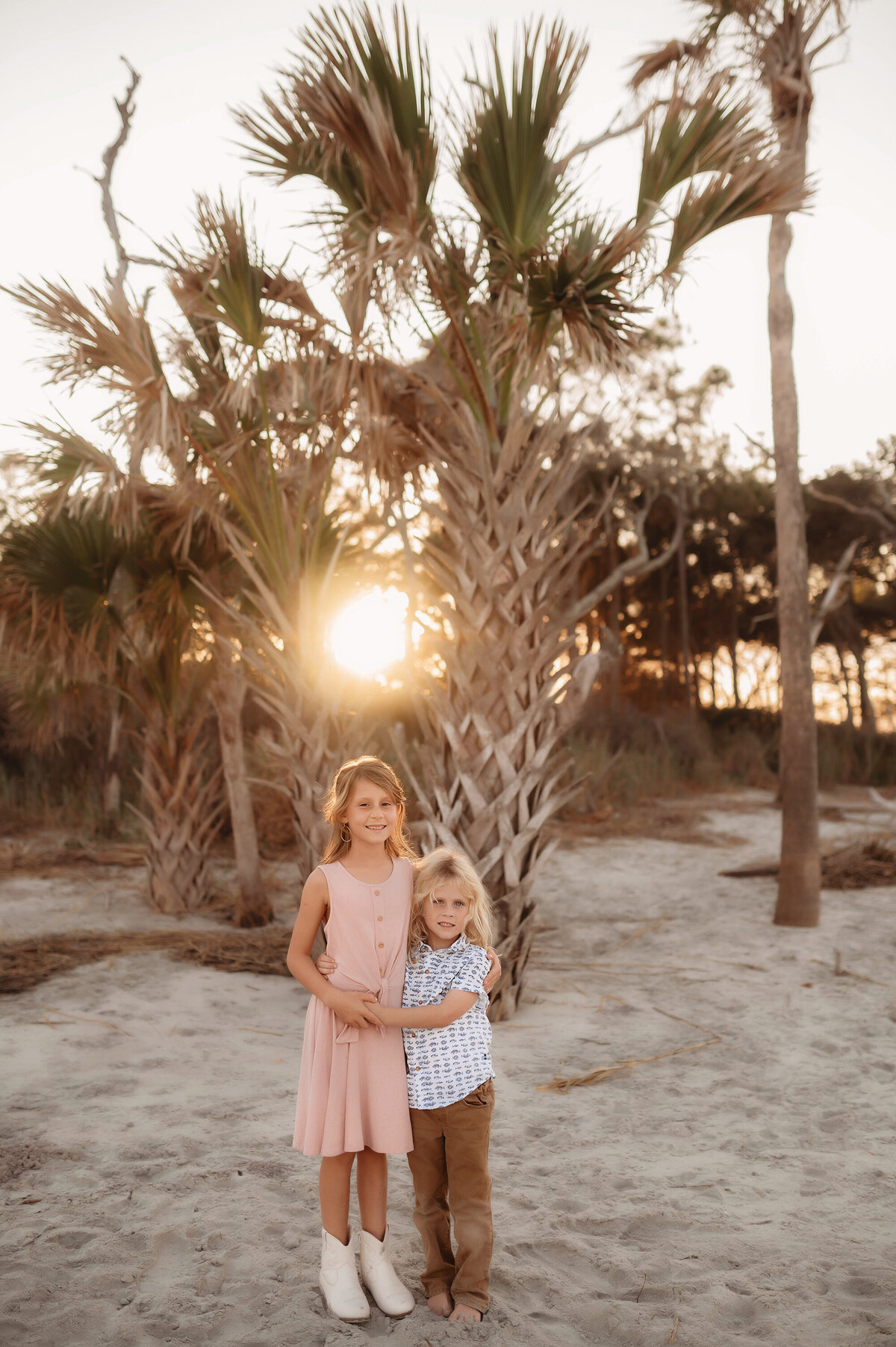Siblings embrace during Family Photos on Folly Beach, South Carolina.