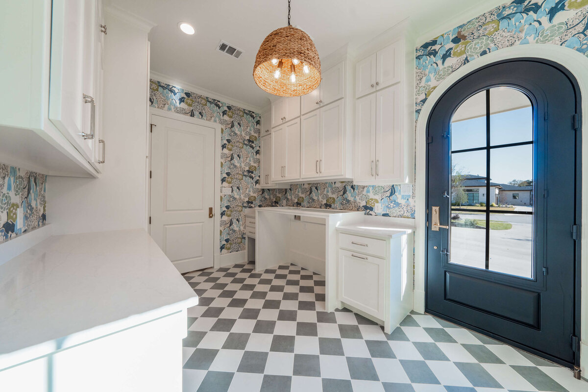 High-end vibrant laundry room with arched door