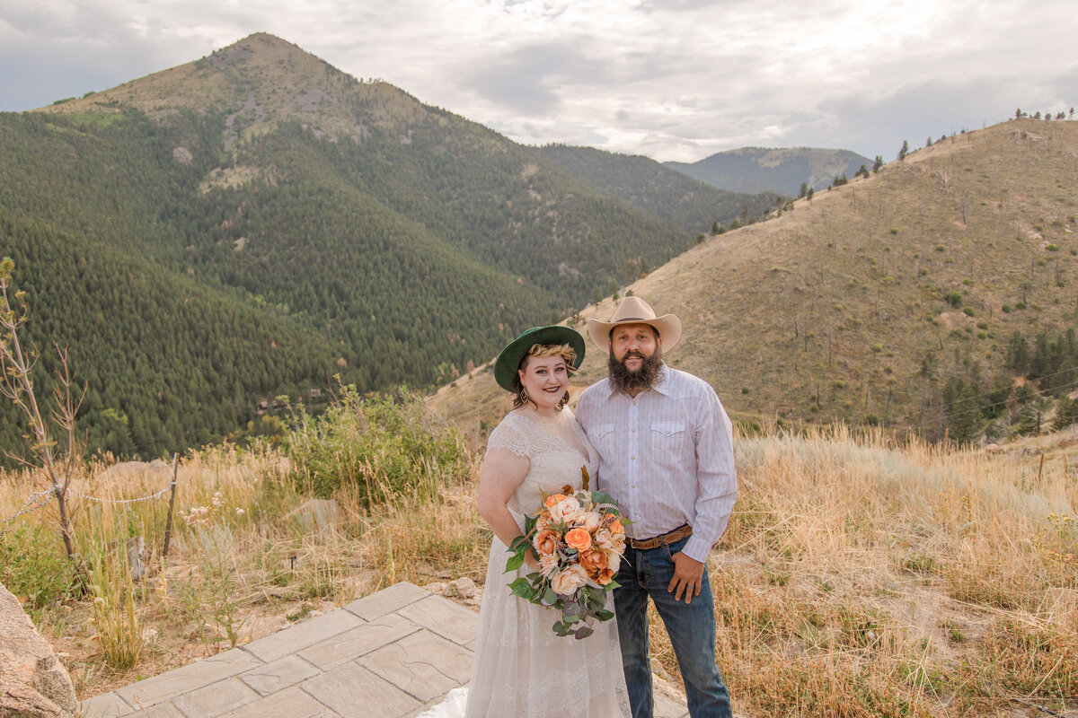 The newly married couple smile for the camera near sugarloaf mountain in Boulder, Colorado